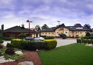 A hotel with a traditional European architectural style, featuring a large building with a gabled roof and a smaller annex with a flat roof.