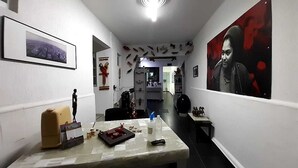 A hallway with a marble counter, framed pictures, and a large poster on the wall. - RCH Suite (Mexico City)