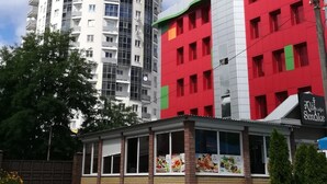 A multi-story building with a modern design, featuring a mix of residential and commercial spaces.
