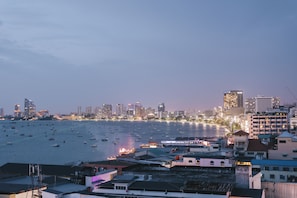 A coastal cityscape with a marina filled with boats, high-rise buildings, and a mix of residential and commercial structures. - Marine Plaza Hotel Pattaya (Pattaya)
