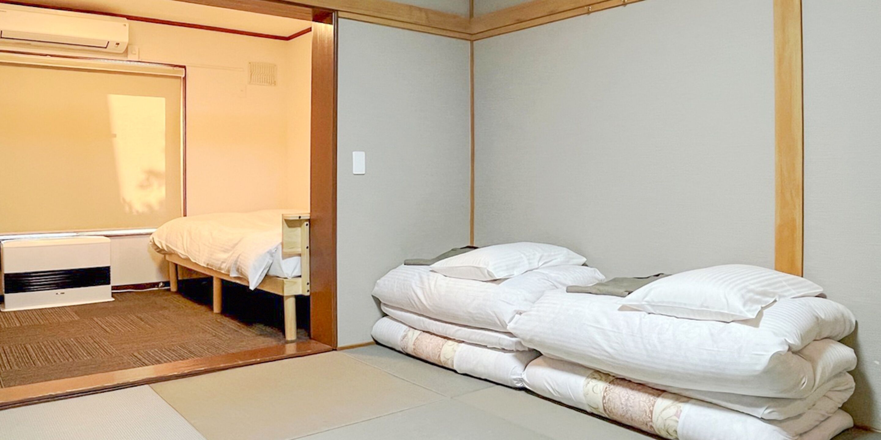 A compact room with a bed, a heater, and a wardrobe.