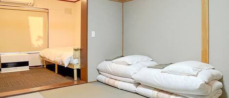 A compact room with a bed, a heater, and a wardrobe.