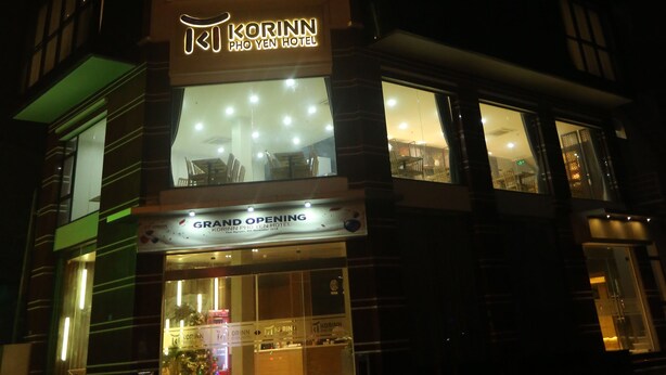 A hotel with a prominent sign for 'Korinn Pho Yen Hotel' and a 'Grand Opening' banner. - Korinn Pho Yen Hotel (Van Xuan)