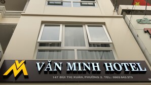 The exterior of Van Minh Hotel with a sign displaying the name and address. - Van Minh Hotel (Xuan Huong - Da Lat)