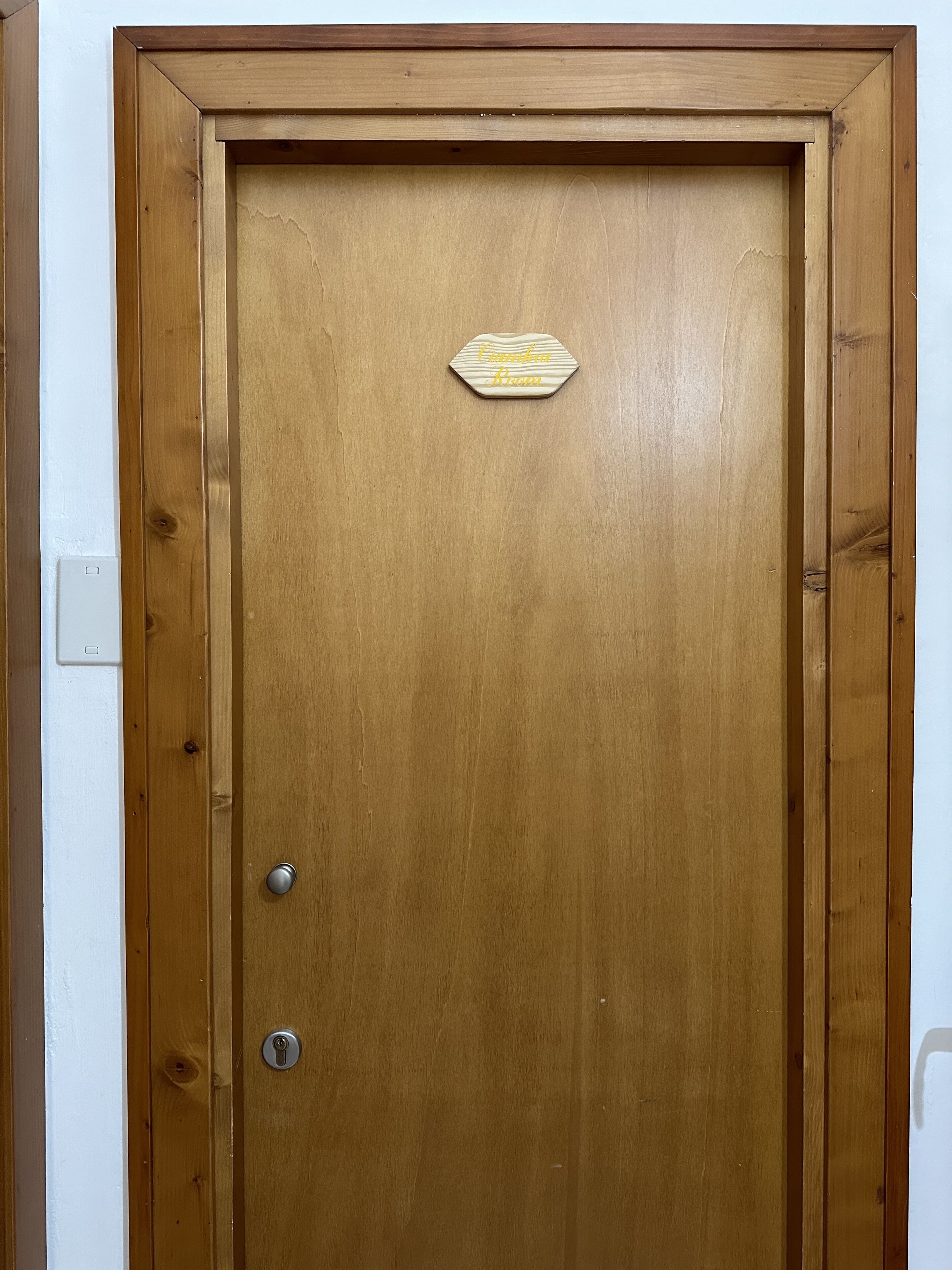A wooden door with a sign that reads "Conference Room."