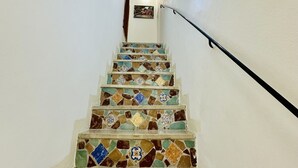A staircase with colorful mosaic tiles and a handrail. - B&B Casa Lilla (Monreale)
