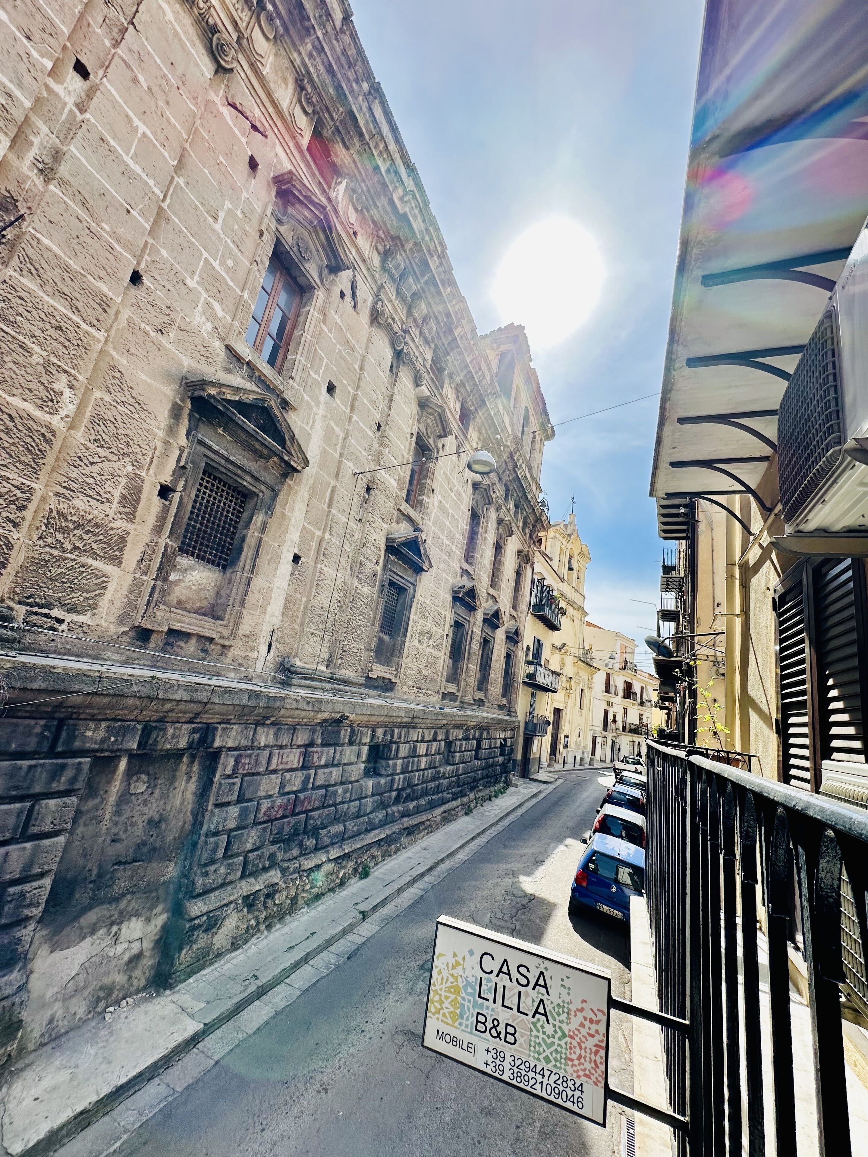 A street view with a building labeled "CASA LILLA B&B" and a signboard with contact information.