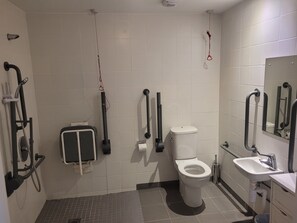 A modern bathroom with a toilet, sink, and shower. - Swuite Galway (Galway)