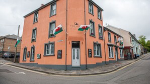 A corner building with a sign reading "The Lion Hotel" and flags.