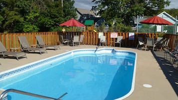 Seasonal outdoor pool, open 6:00 AM to 9:00 PM, pool umbrellas