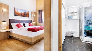 A modern bedroom with a wooden bed, a nightstand, and a wall-mounted lamp.
