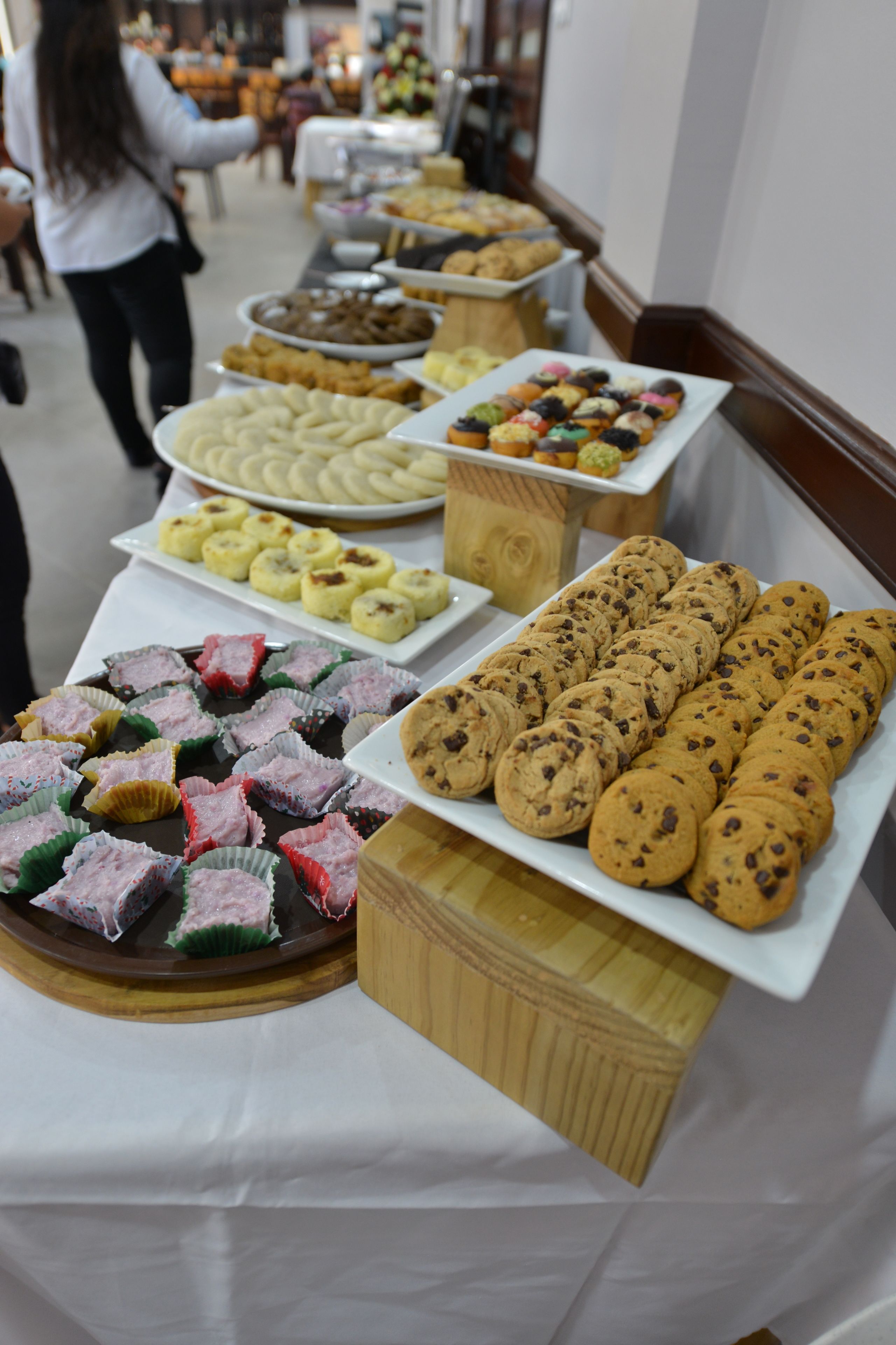 A buffet table with various baked goods and pastries.