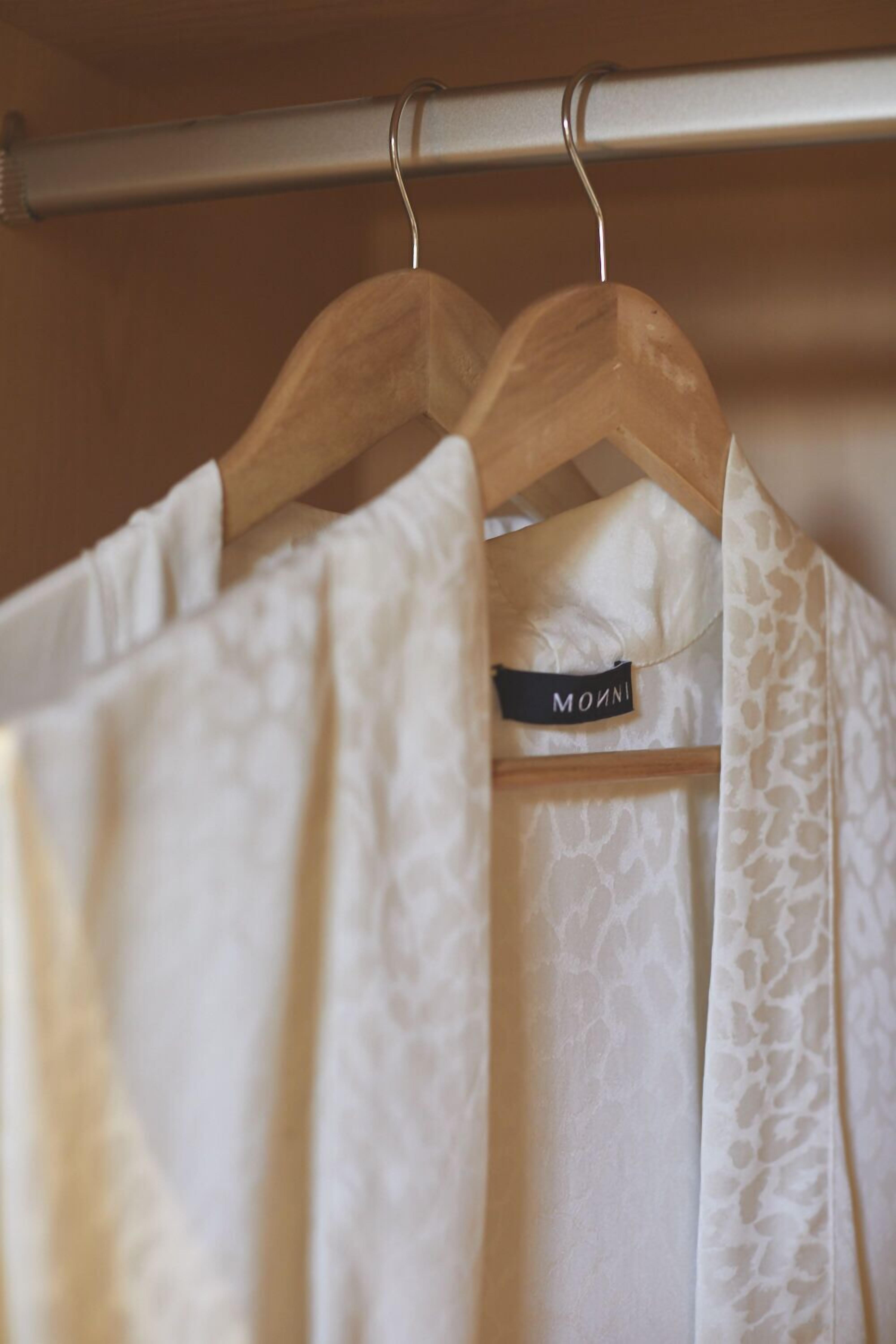 A clothing rack with hangers holding garments.