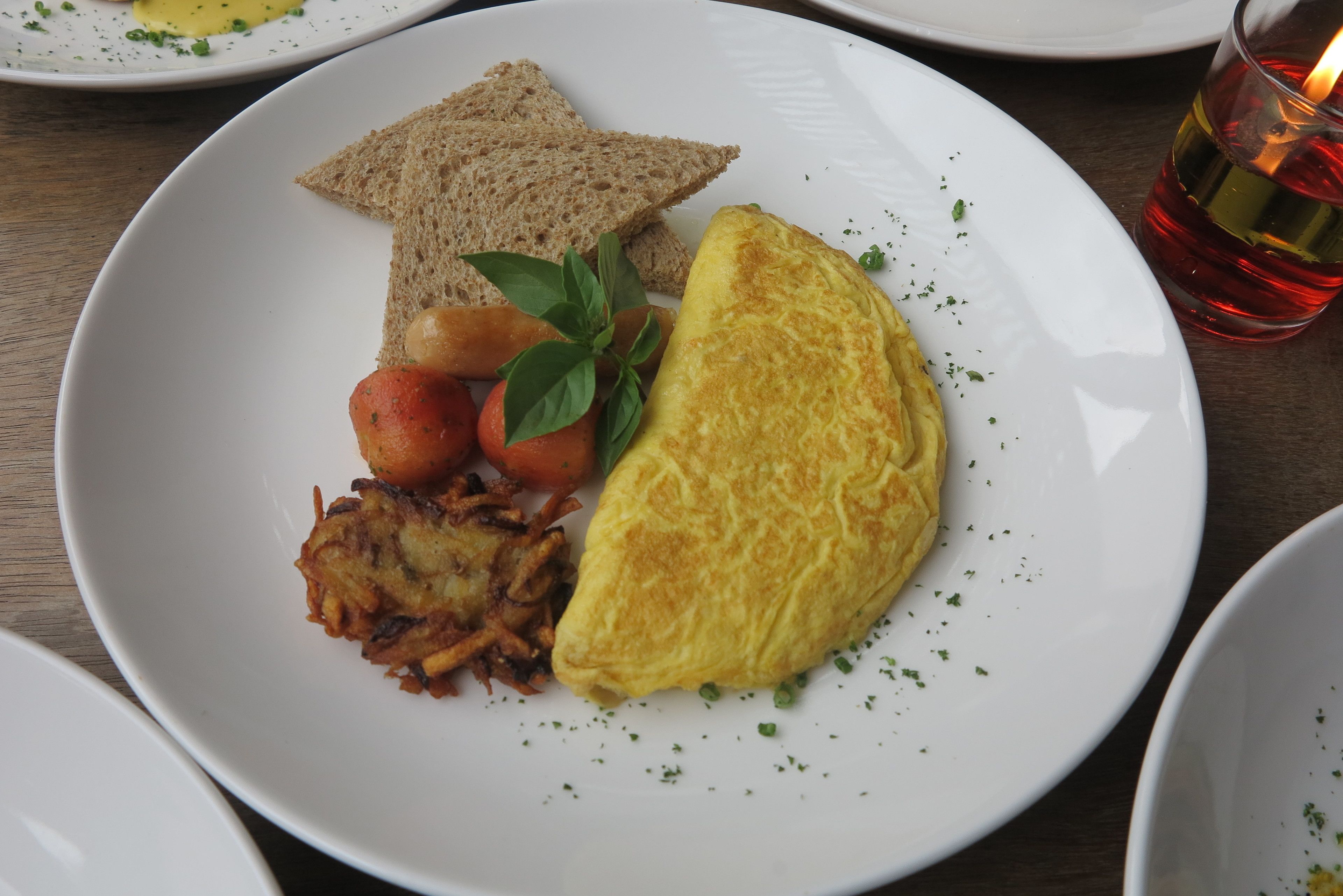 A plate with toast, an omelette, and hash browns.