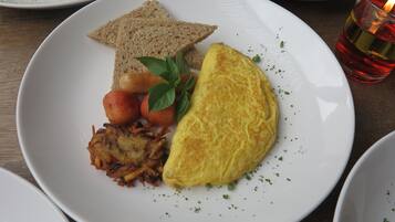 A plate with toast, an omelette, and hash browns.