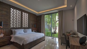 A modern bedroom with a large bed, a desk, and a TV. - Kemangi Bed & Breakfast (Kuta)
