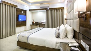 A modern hotel room with a large bed, a desk, and a television. - White Palace Hotel (Dhaka)