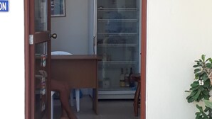 A doorway leading into a room with a refrigerator, a small table, and a chair. - Hospedaje Mother Fanny (Puerto Villamil)