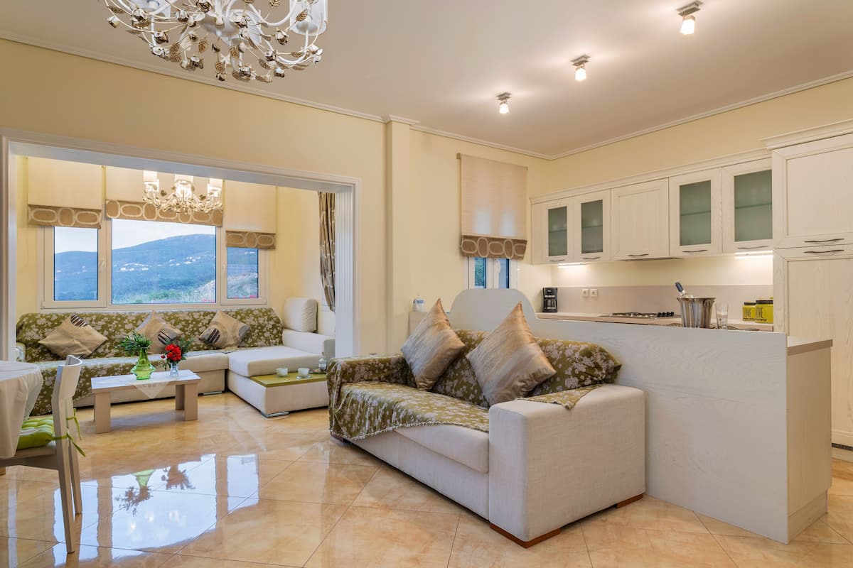 A modern living room with a sofa, a coffee table, and a dining area.