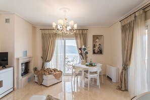 Luxury Suite (Afroditi) | Living area | Plasma TV, fireplace - Grand View Villas (Samos)