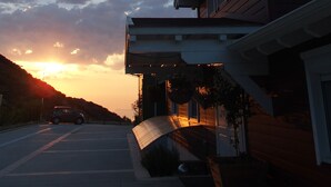 A modern house with a sloped roof and a covered driveway. - Ktima Noosfera wellness & retreat center (Xylokastro-Evrostina)