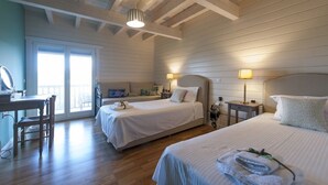 A hotel room with two beds, a desk, and a chair. There is a balcony with a view. - Ktima Noosfera wellness & retreat center (Xylokastro-Evrostina)