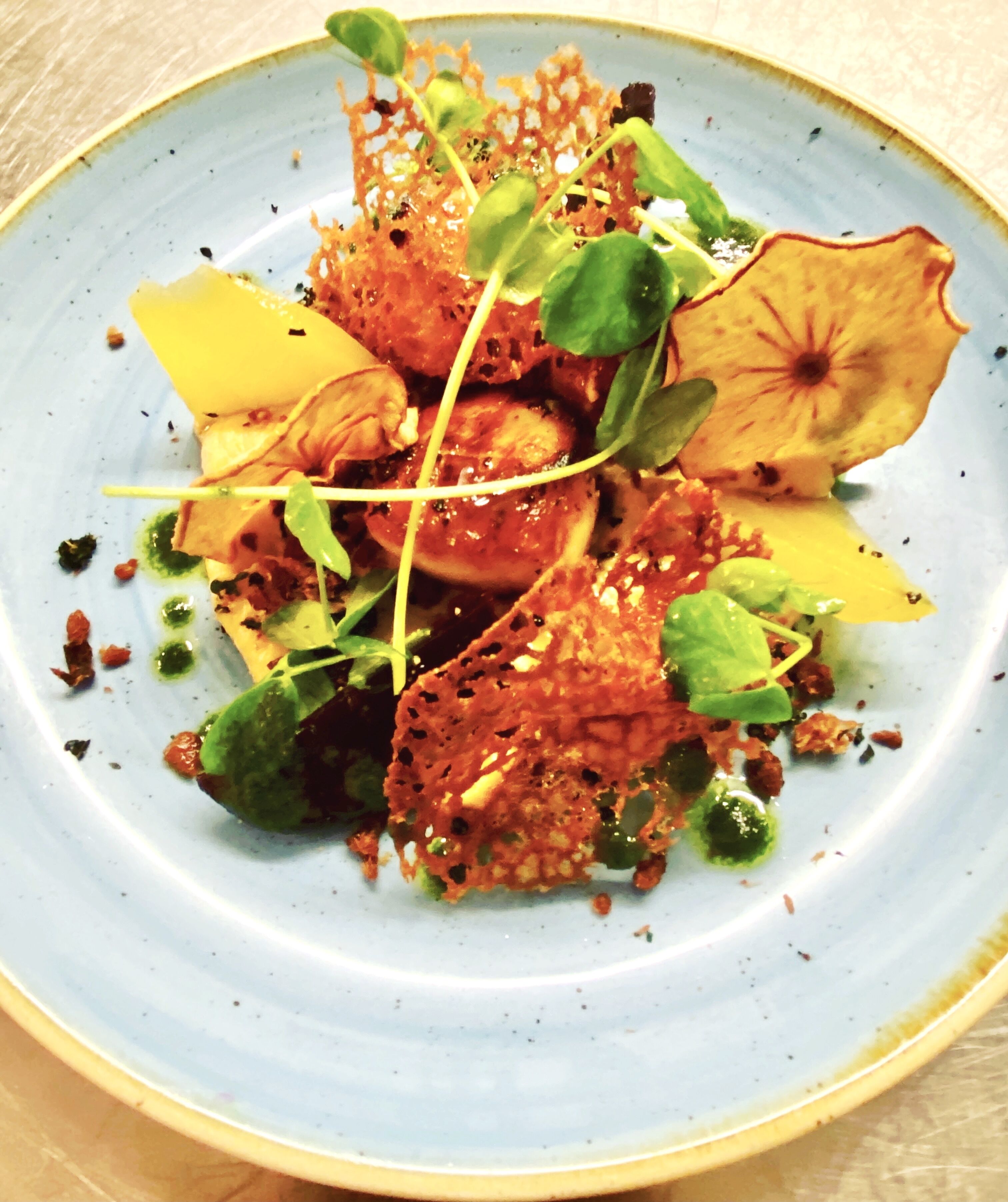 A plate of food with various vegetables and garnishes.
