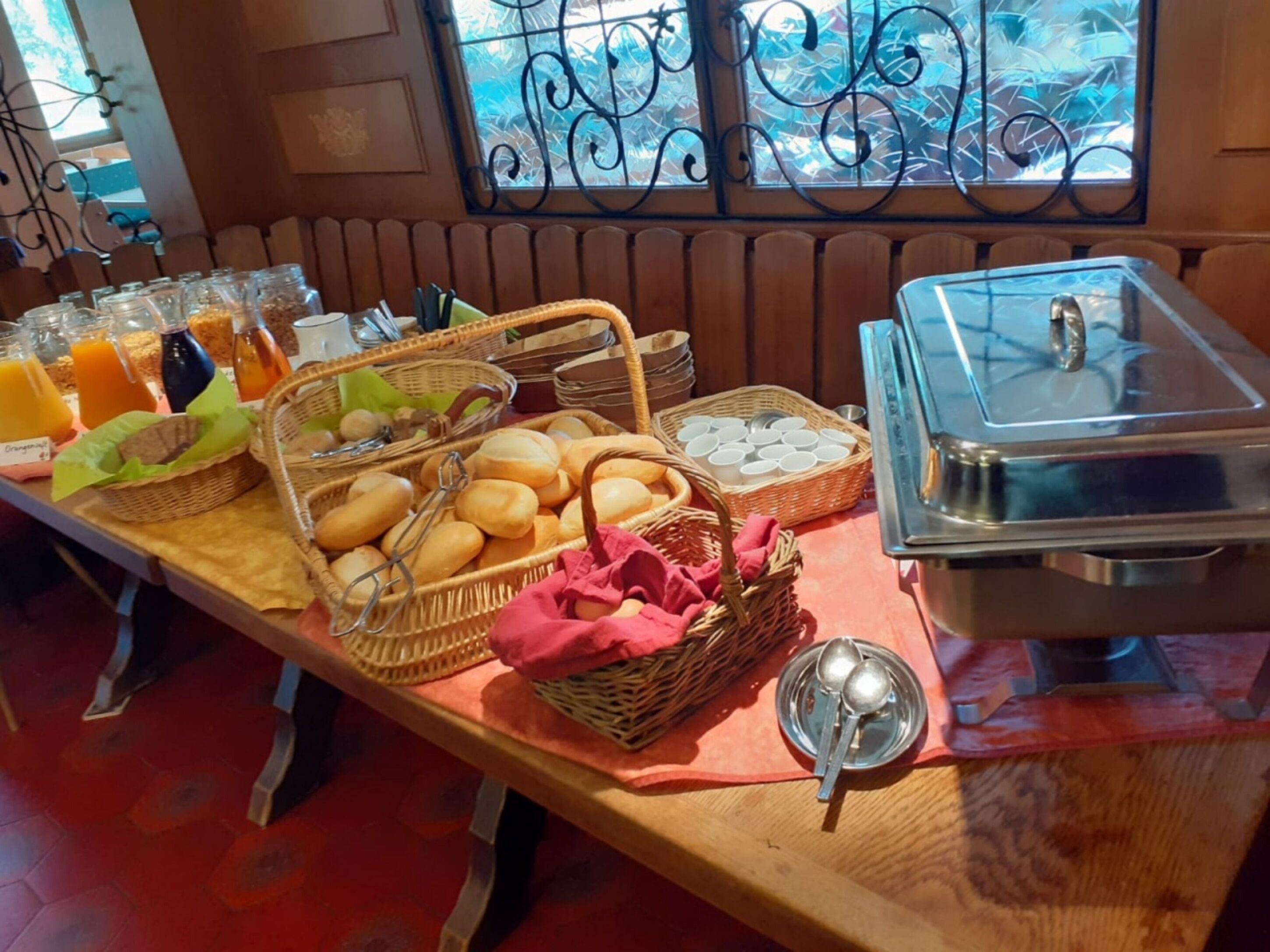 A breakfast buffet with various food items and beverages.