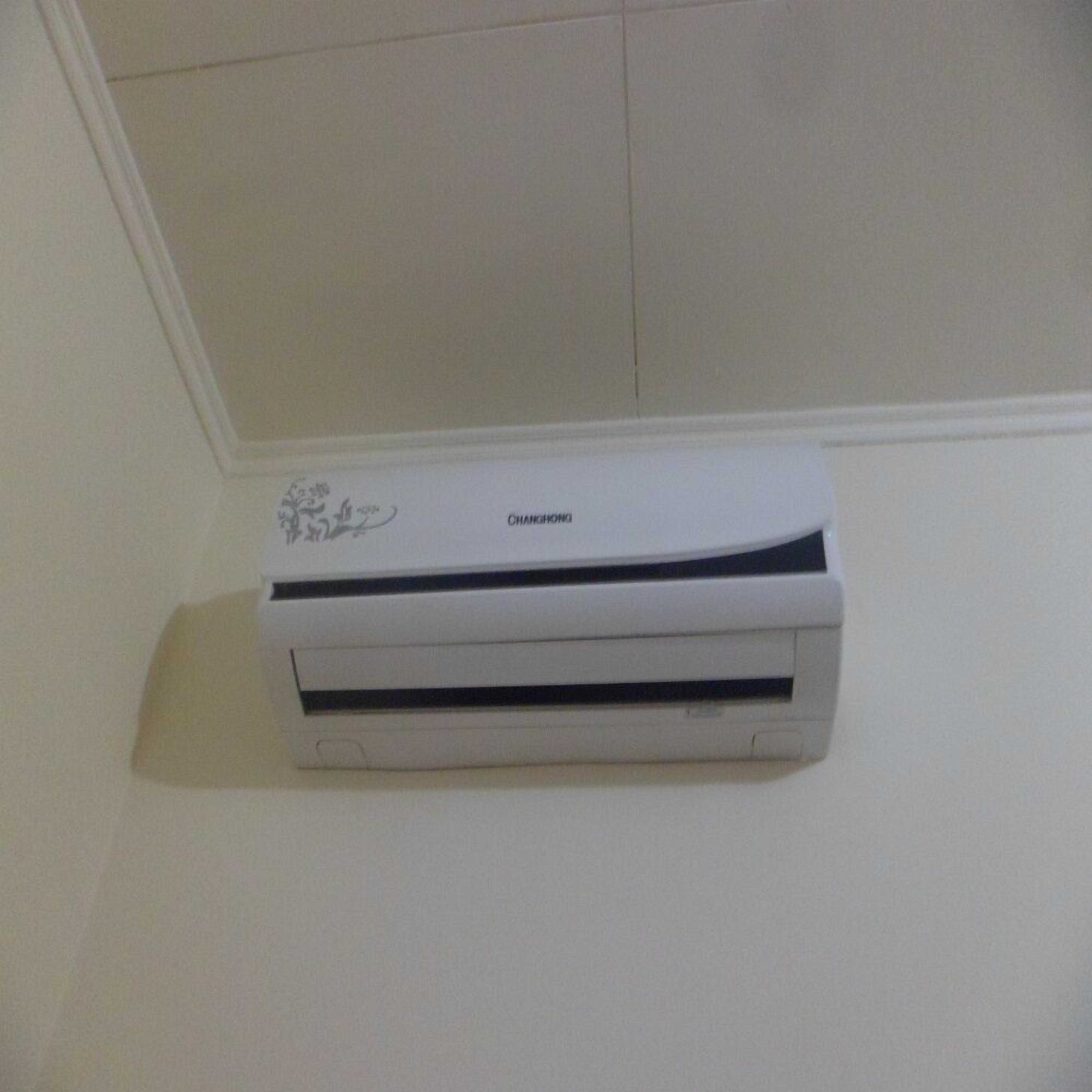 A white air conditioning unit mounted on a wall.