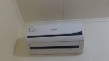 A white air conditioning unit mounted on a wall.