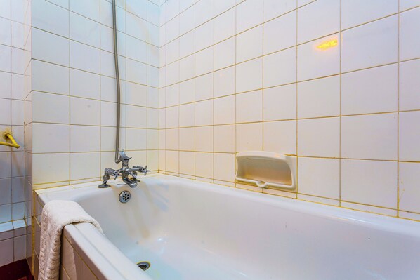 Combined shower/bathtub, deep-soaking bathtub, towels