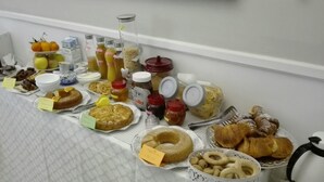 A breakfast buffet with various food items and condiments. - Conte di cavour (Foggia)