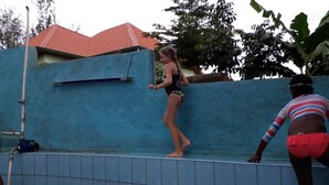 A swimming pool with tiled walls and a blue exterior wall. - Colours Club Spa and Garden Resort (Kigali)