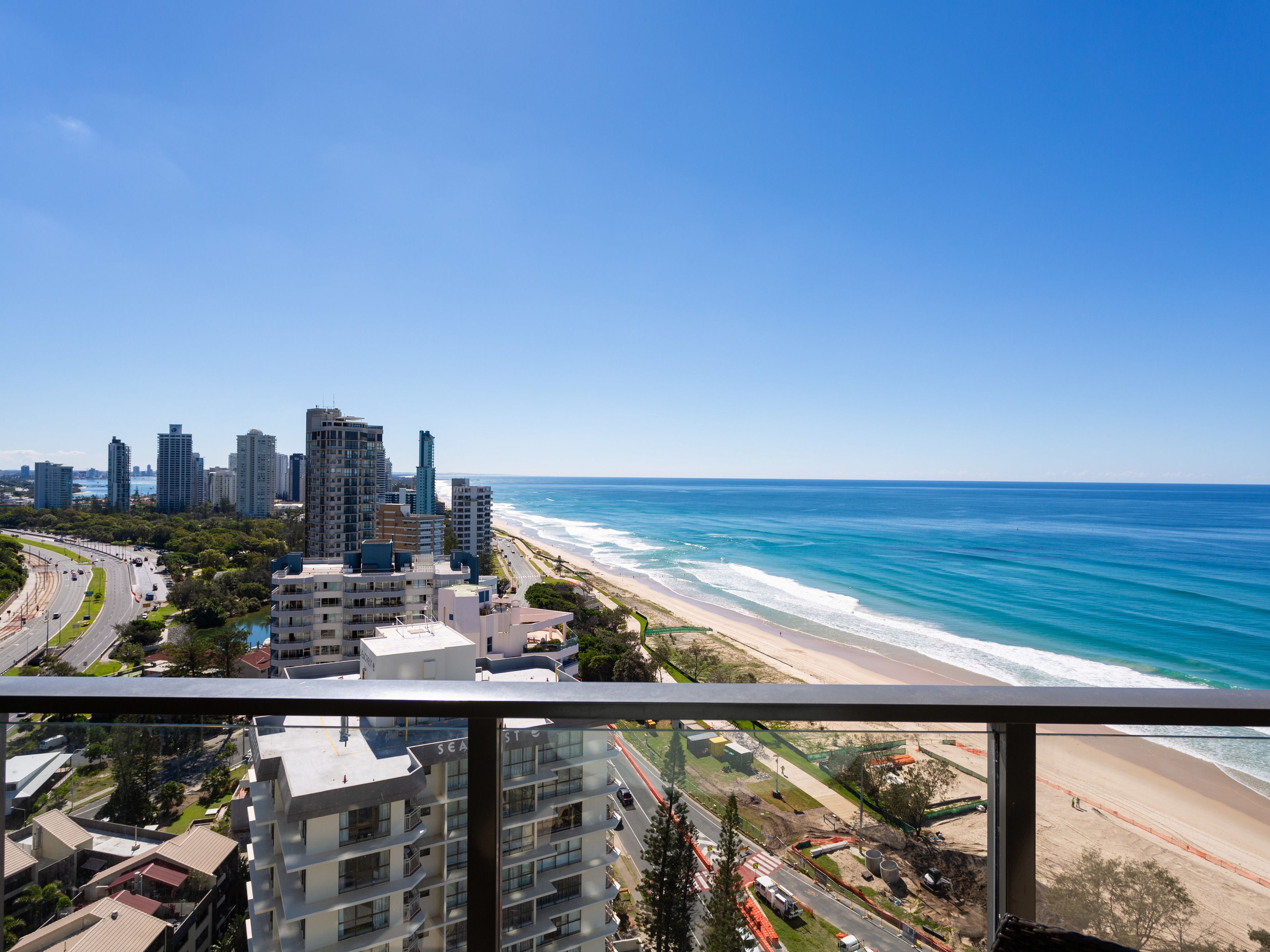 A high-rise hotel with a view of the beach and ocean.