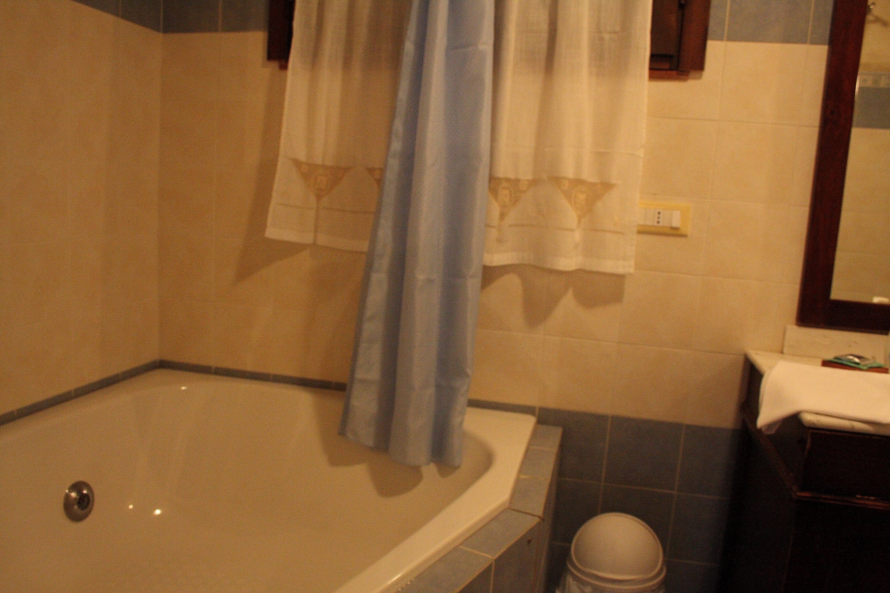 A bathroom with a bathtub, a toilet, and a sink.