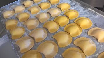 A tray of ravioli on a baking sheet.