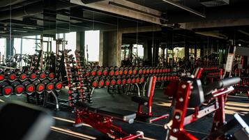 A gym with various exercise equipment, including dumbbells and weight machines.