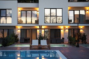 A modern building with a pool, outdoor seating, and large windows. - Medite Spa Resort & Villas (Sandanski)