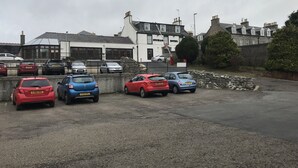A parking lot with several cars parked in front of a hotel. - The Buchan Hotel (Ellon)