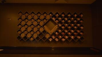 A wall with a geometric pattern of shelves holding neatly folded towels.