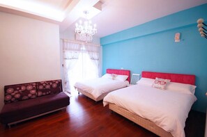 A bedroom with two beds, a sofa, a chandelier, and a window with curtains.