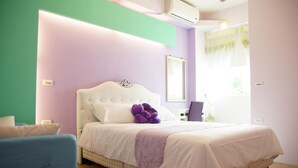 A bedroom with a bed, a chair, a mirror, and a window with curtains. - Man Lu B&B (Hualien City)