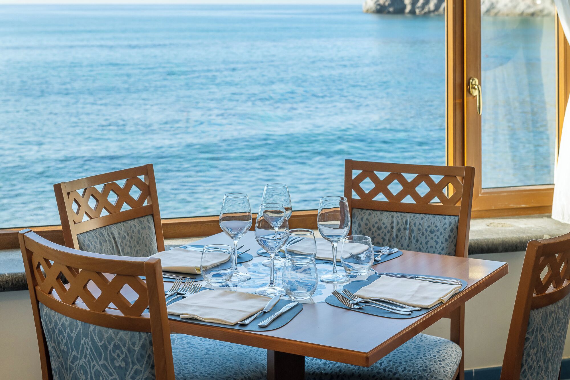 A table set for two with a view of the sea.