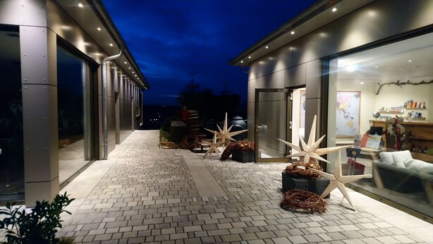 A pathway leading to a modern building with large windows and a brick floor. - Kirschberghof - Adults Only (Sommerhausen)