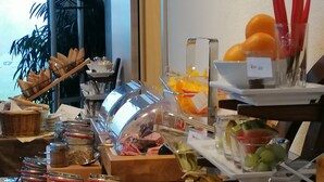 A buffet with various food items and beverages, including fruits, pastries, and a coffee station. - Kirschberghof - Adults Only (Sommerhausen)