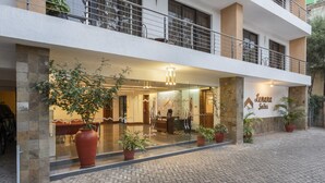 A hotel entrance with a reception desk, potted plants, and a sign reading "Lenara Suites". - Lenana Suites (Nairobi)