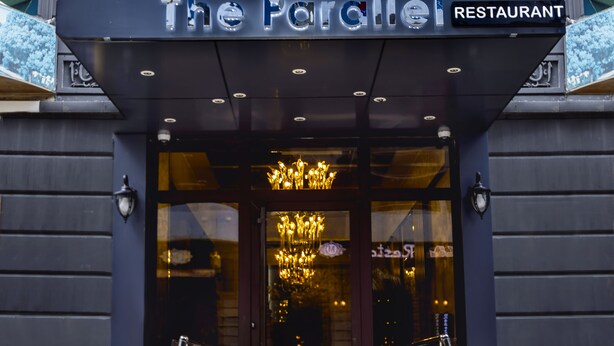 The entrance to Hotel The Parallel with a sign indicating it is a restaurant. - Parallel Hotel (Baku)