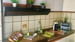 A kitchen with a microwave, toaster, and various food items on the counter. - Casa Vacanze Da Angela (Sciacca)