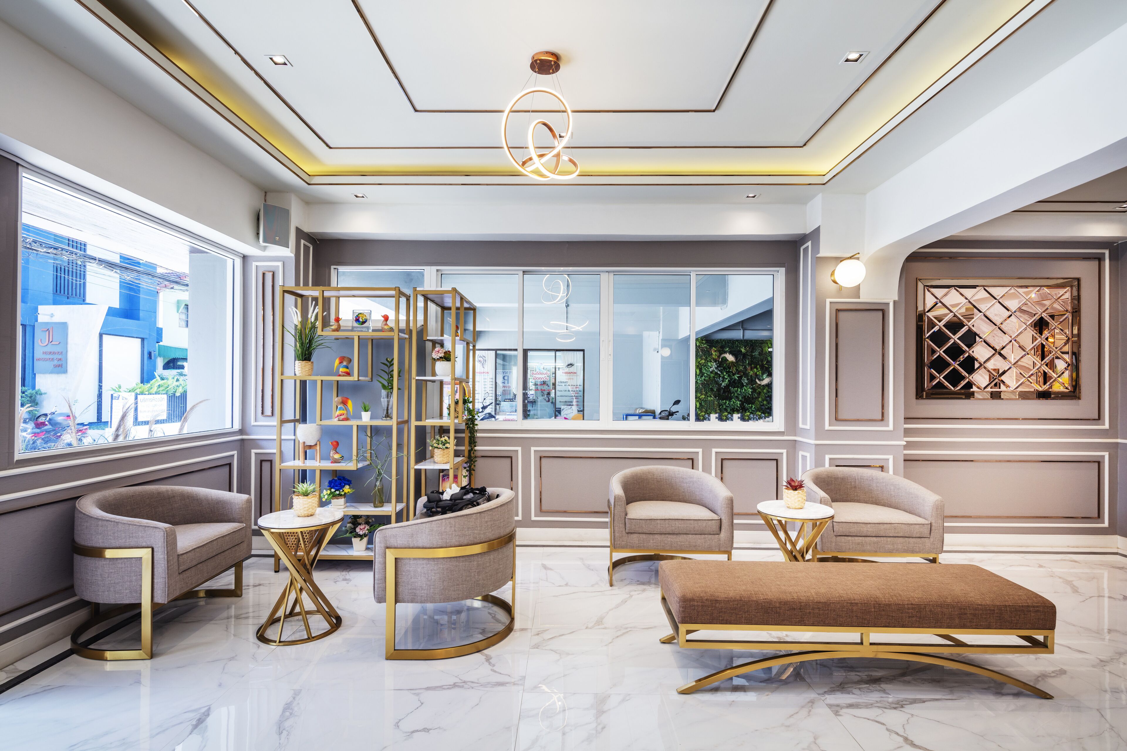 A modern living room with a marble floor, a round coffee table, two armchairs, a sofa, and a decorative wall unit.