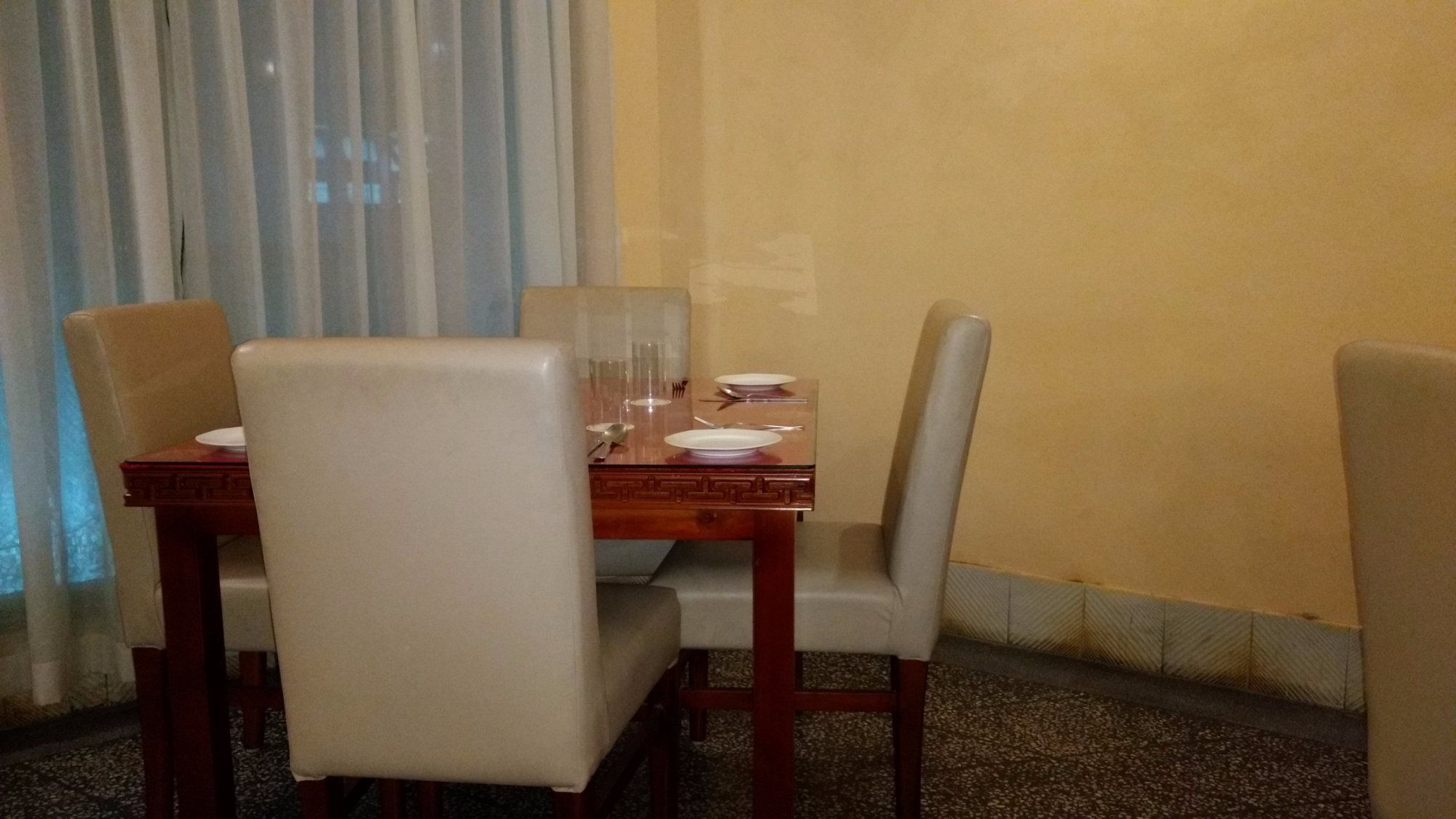A dining area with a wooden table and four chairs.